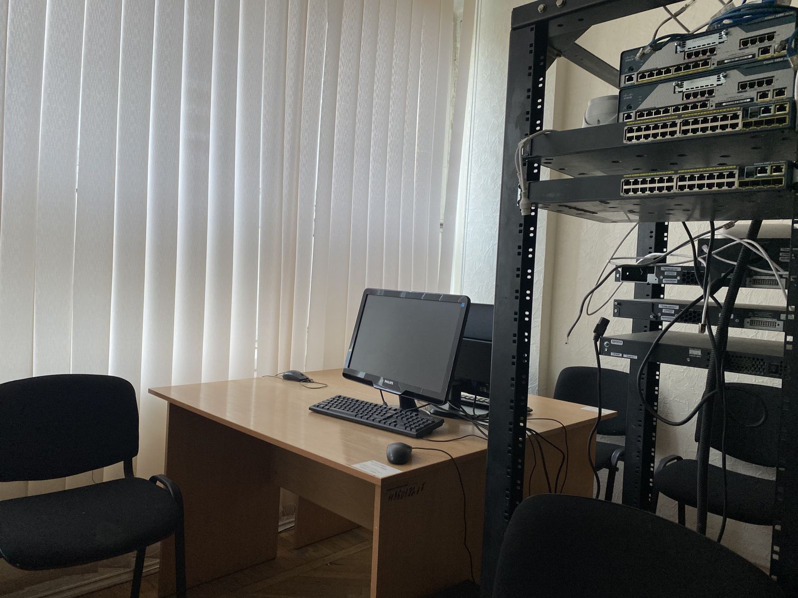 Робоче місце студента поруч зі стійкою комутаторів